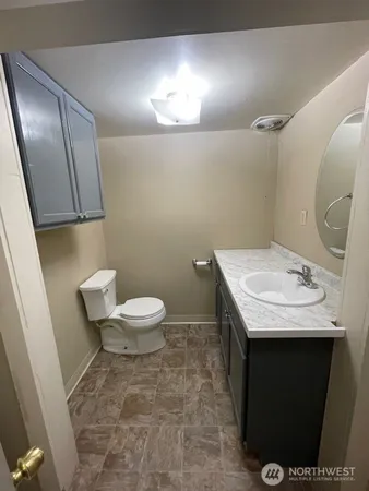 a kitchen with granite countertop a sink a stove and cabinets