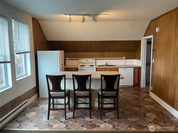a kitchen with a dining table and chairs