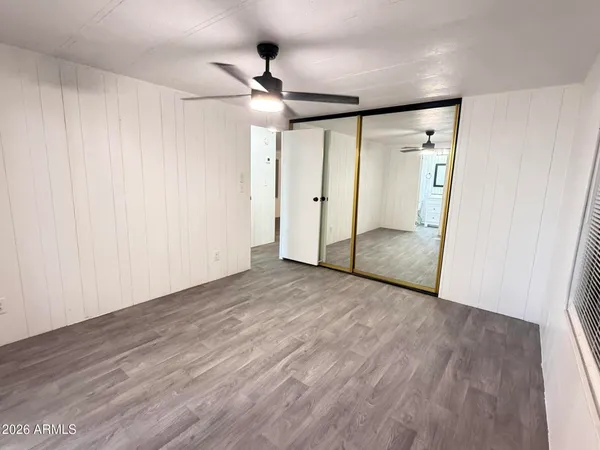 a view of empty room with wooden floor