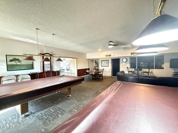 a living room with lots of furniture and kitchen view