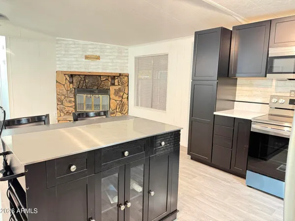 a kitchen with stainless steel appliances a sink cabinets and wooden floor