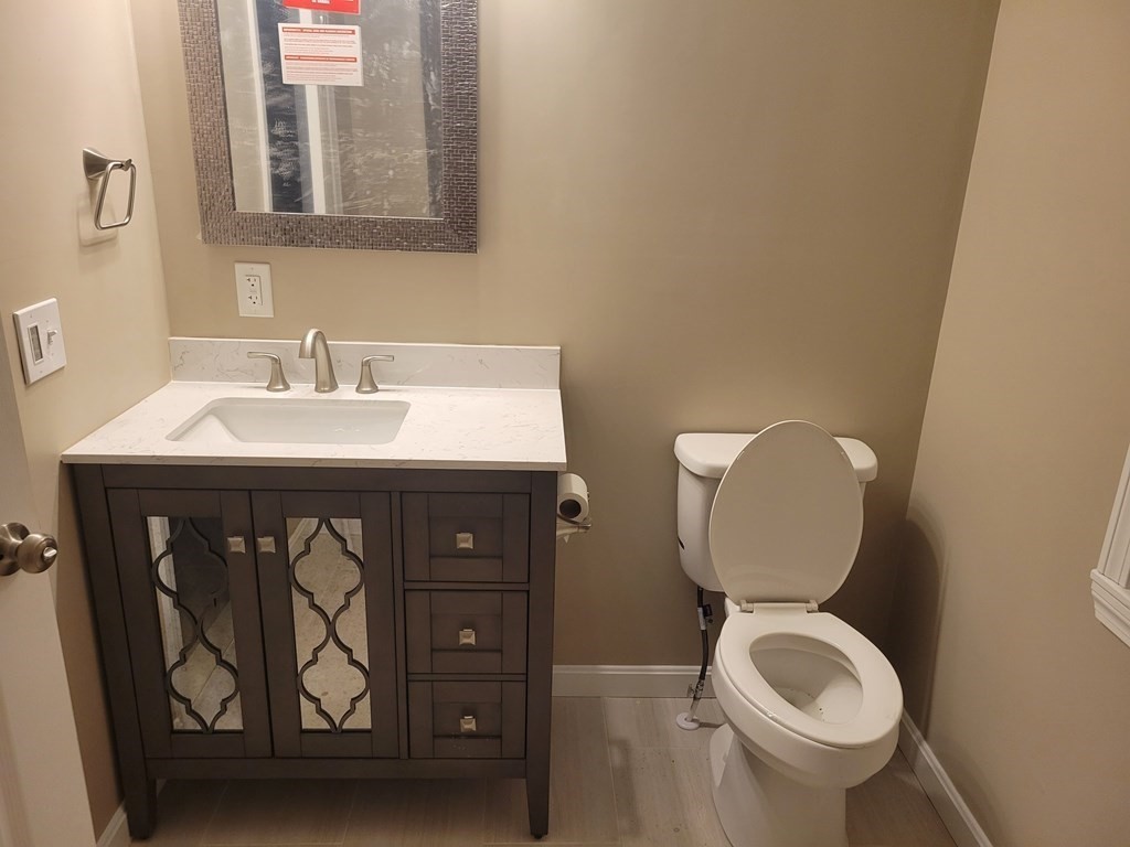 89 Devir Street Malden, MA 02148 - Photo 19 of 24 a bathroom with a toilet sink and mirror