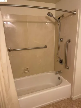 a bathroom with a bath tub and shower