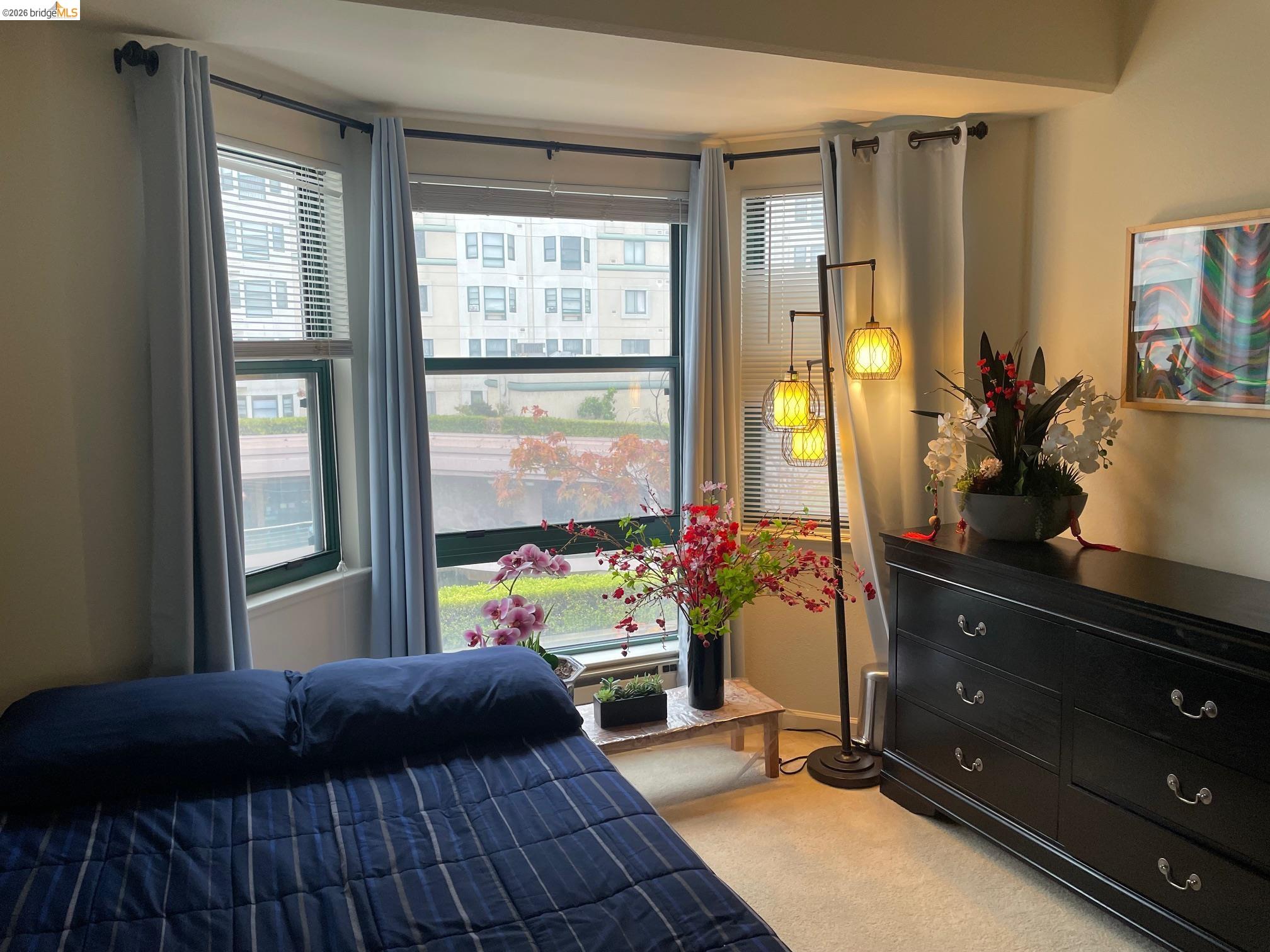 989 Webster Street, Unit 450 Oakland, CA 94607 - Photo 9 of 16 a bedroom with a bed and a potted plant