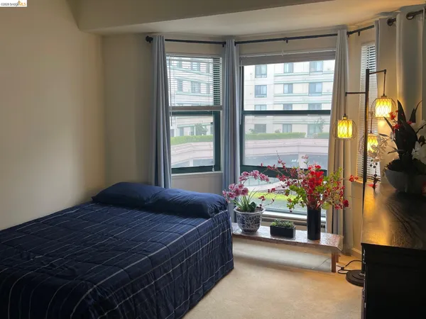 a bedroom with bed and a window