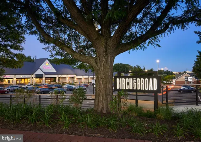 a front view of a building with trees