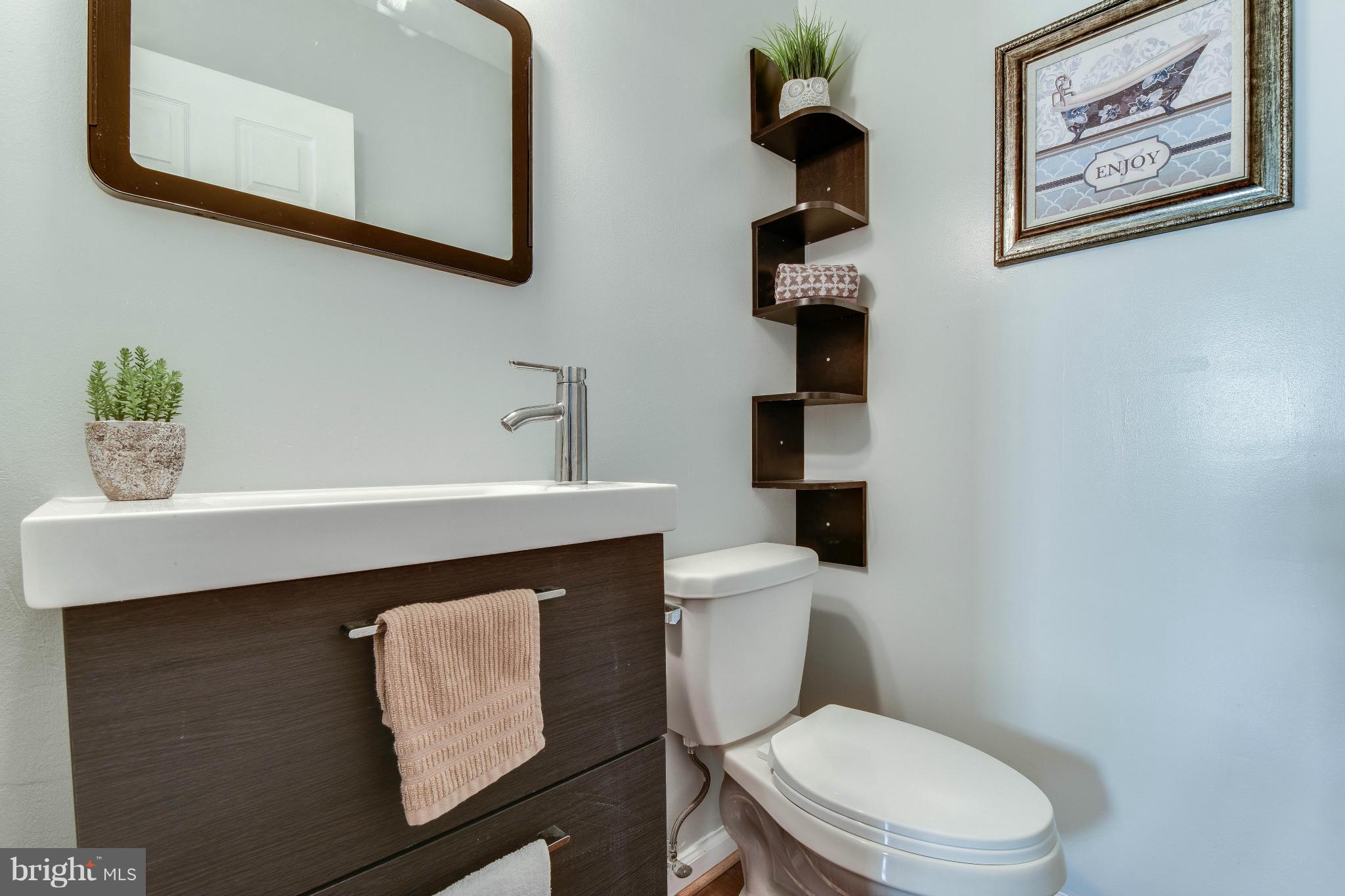 14001 Pond View Road Silver Spring, MD 20905 - Photo 12 of 30 a bathroom with a toilet a sink and mirror