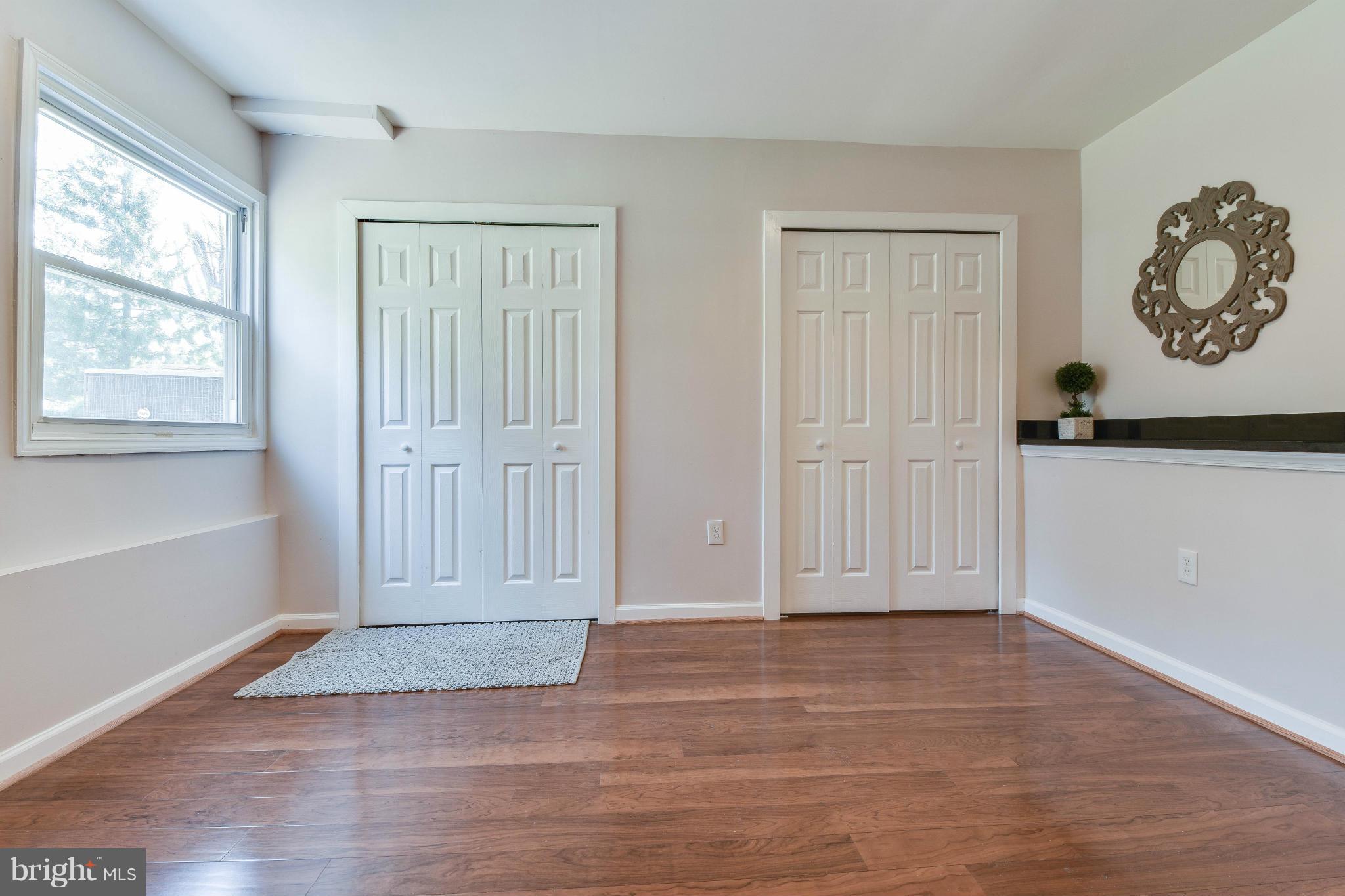 14001 Pond View Road Silver Spring, MD 20905 - Photo 14 of 30 an empty room with wooden floor and windows