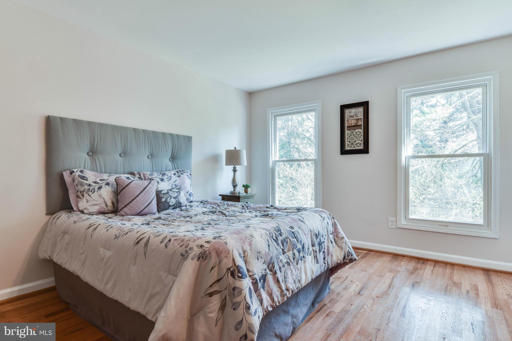 14001 Pond View Road Silver Spring, MD 20905 - Photo 15 of 30 a bedroom with a large bed and a window
