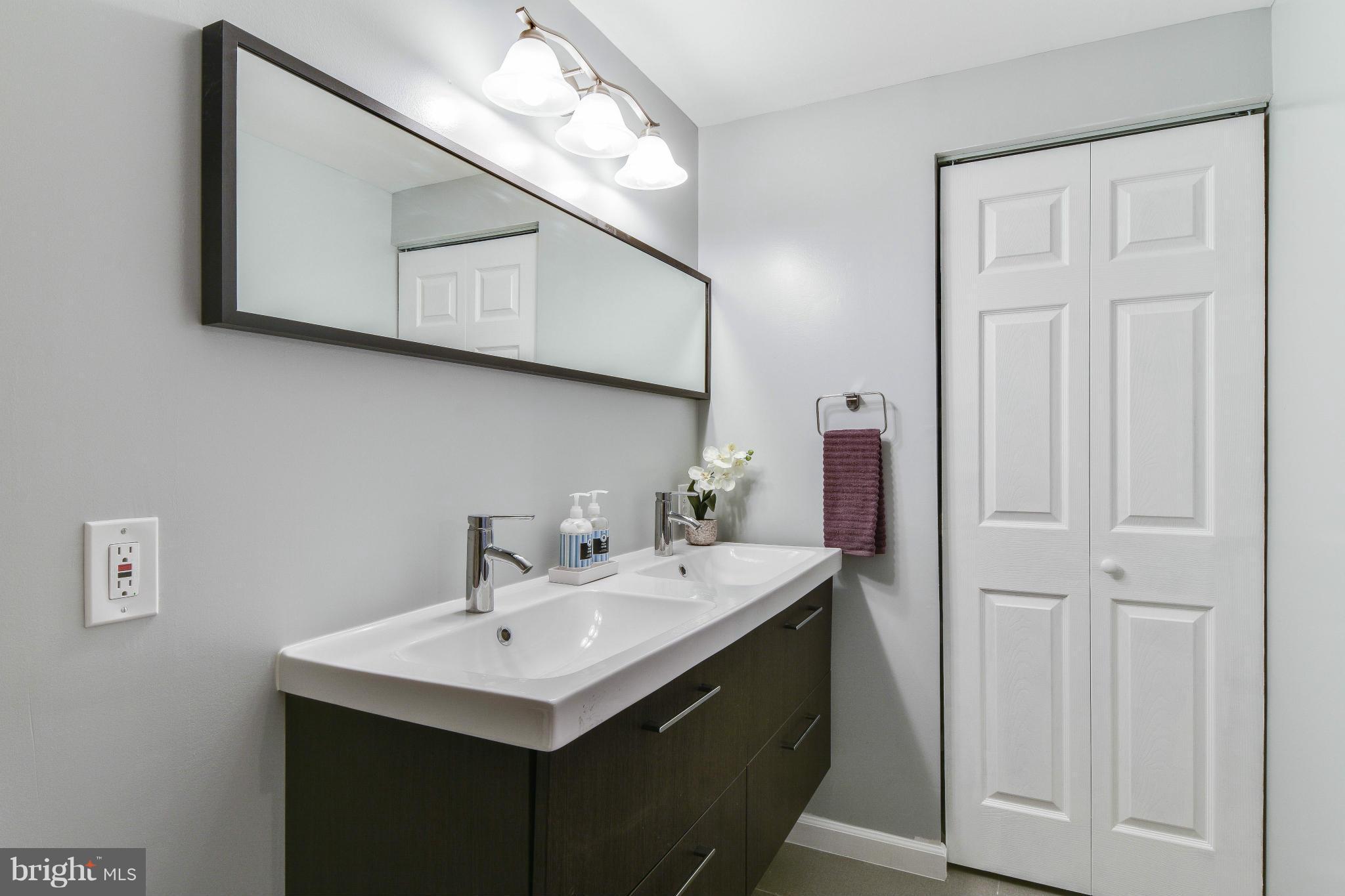 14001 Pond View Road Silver Spring, MD 20905 - Photo 17 of 30 a bathroom with a sink and a mirror