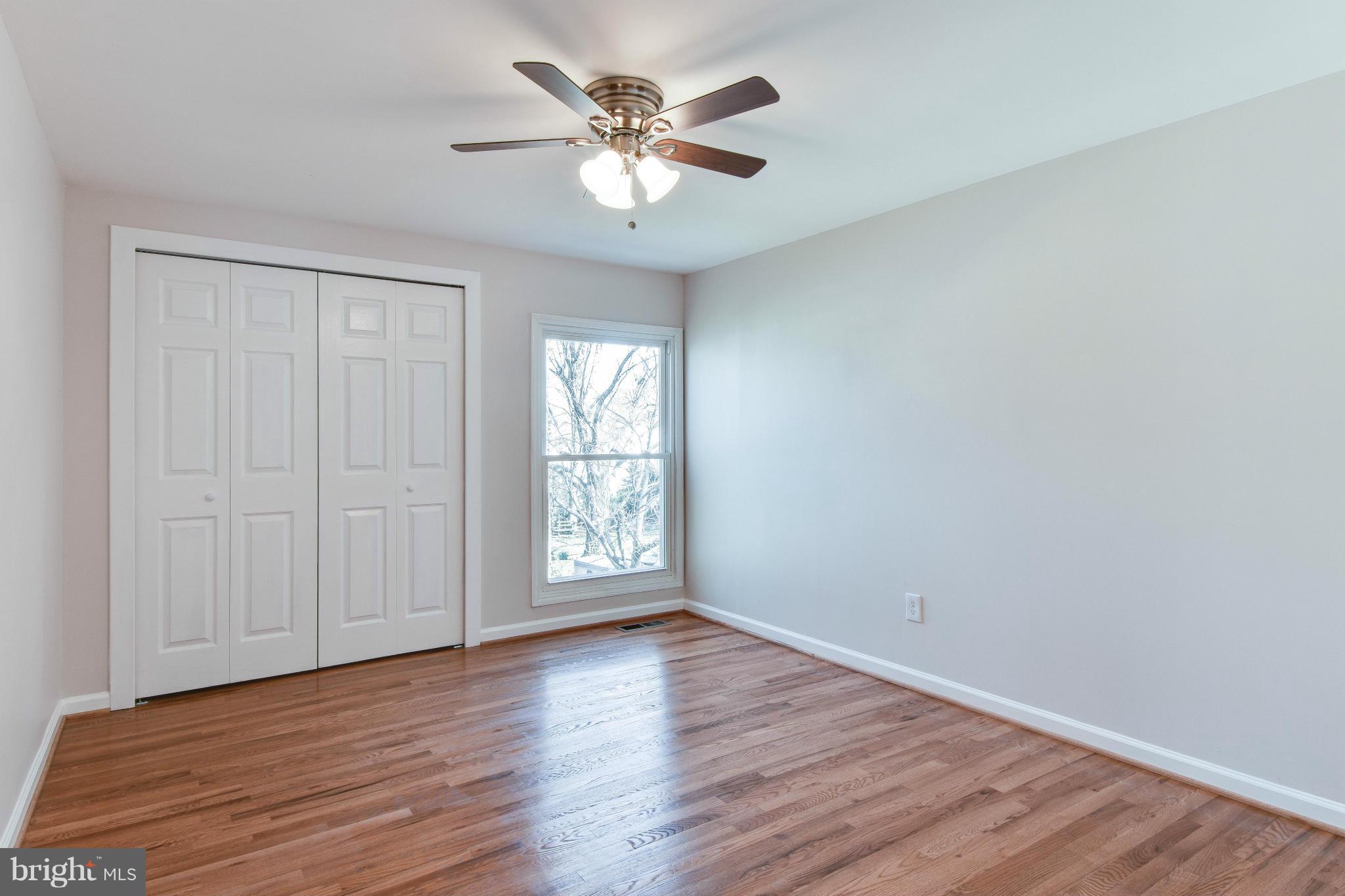 14001 Pond View Road Silver Spring, MD 20905 - Photo 21 of 30 an empty room with wooden floor and windows