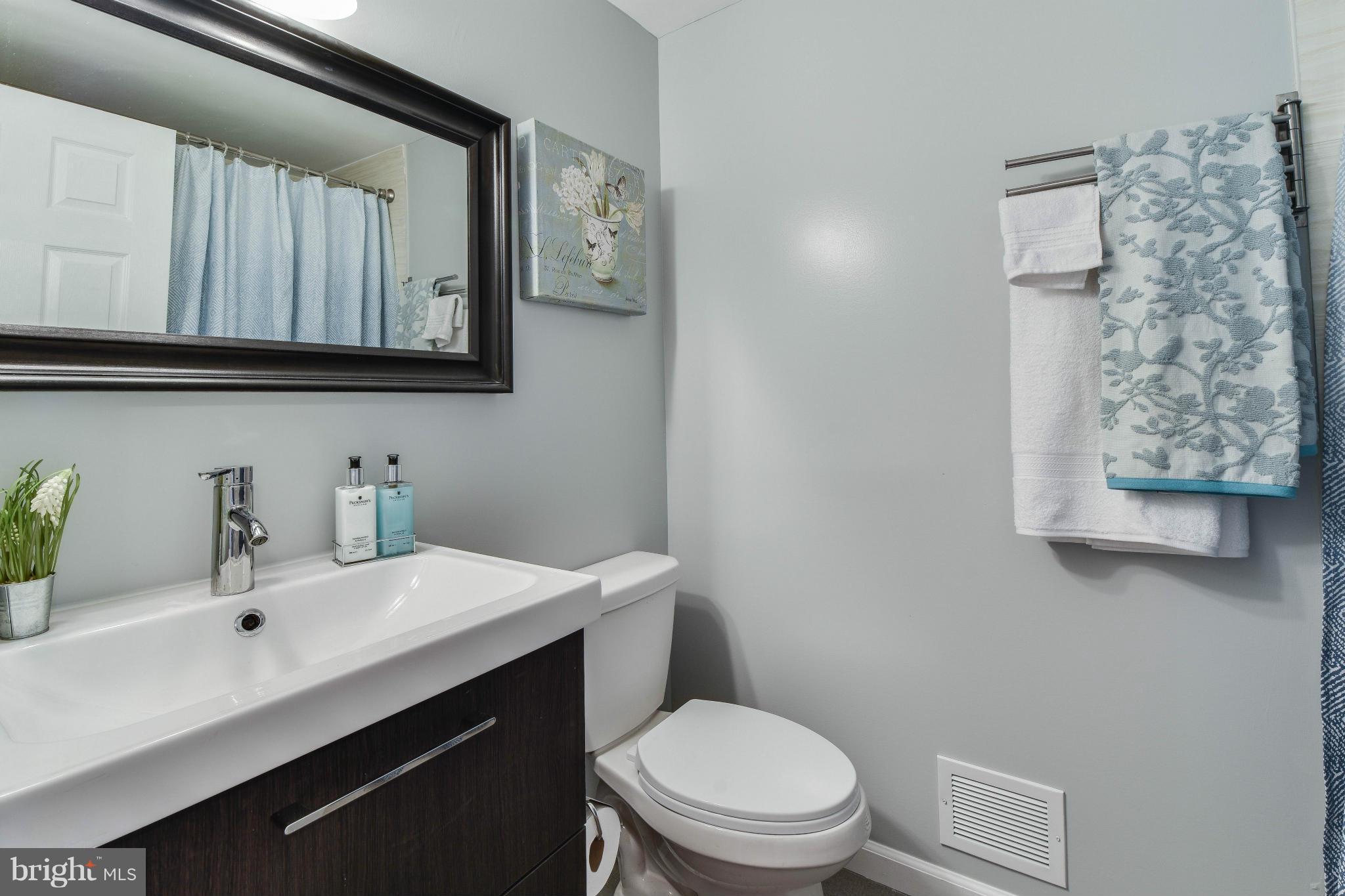 14001 Pond View Road Silver Spring, MD 20905 - Photo 22 of 30 a bathroom with a toilet sink and mirror