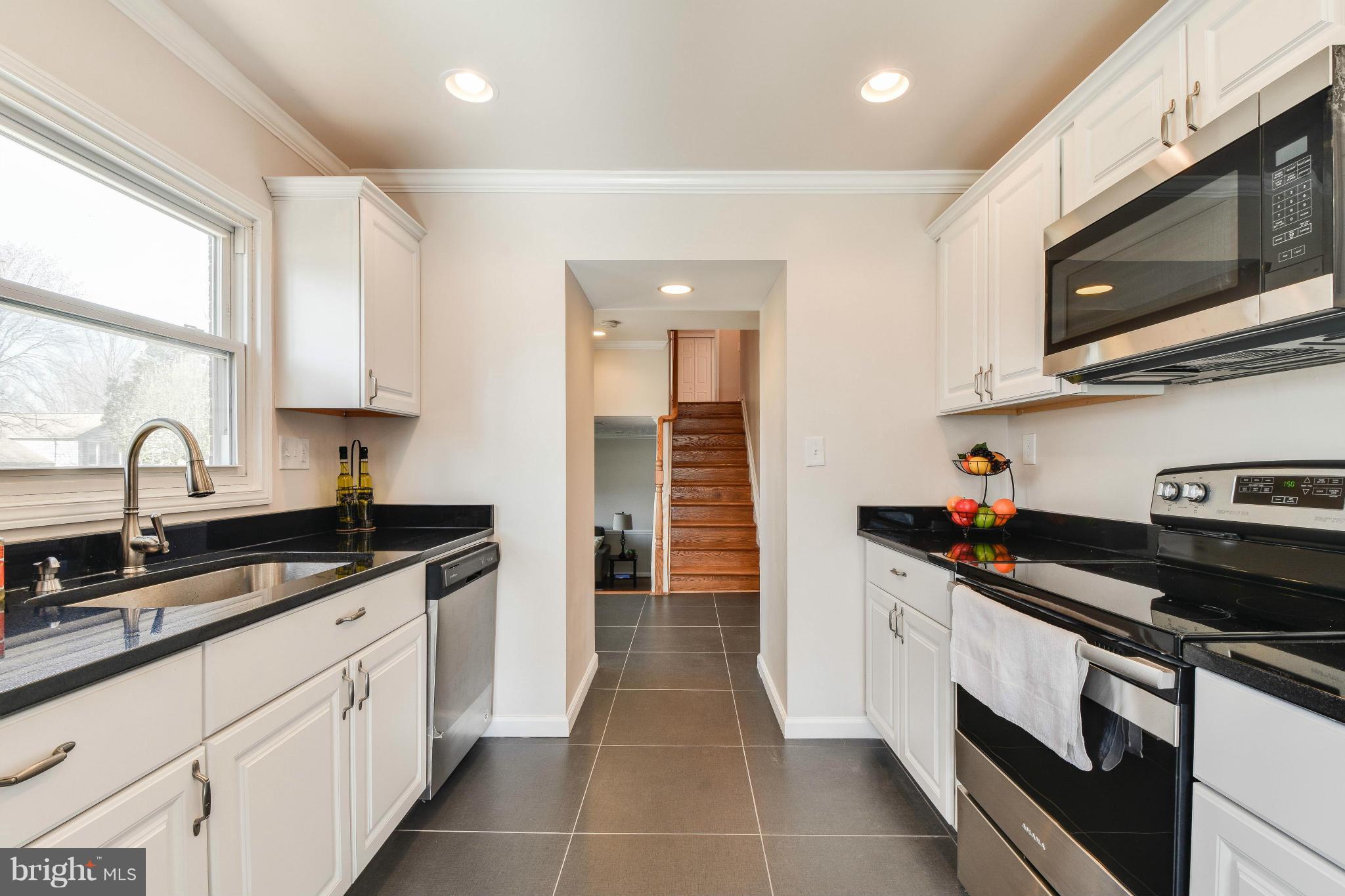 14001 Pond View Road Silver Spring, MD 20905 - Photo 6 of 30 a kitchen with stainless steel appliances granite countertop a sink and a stove