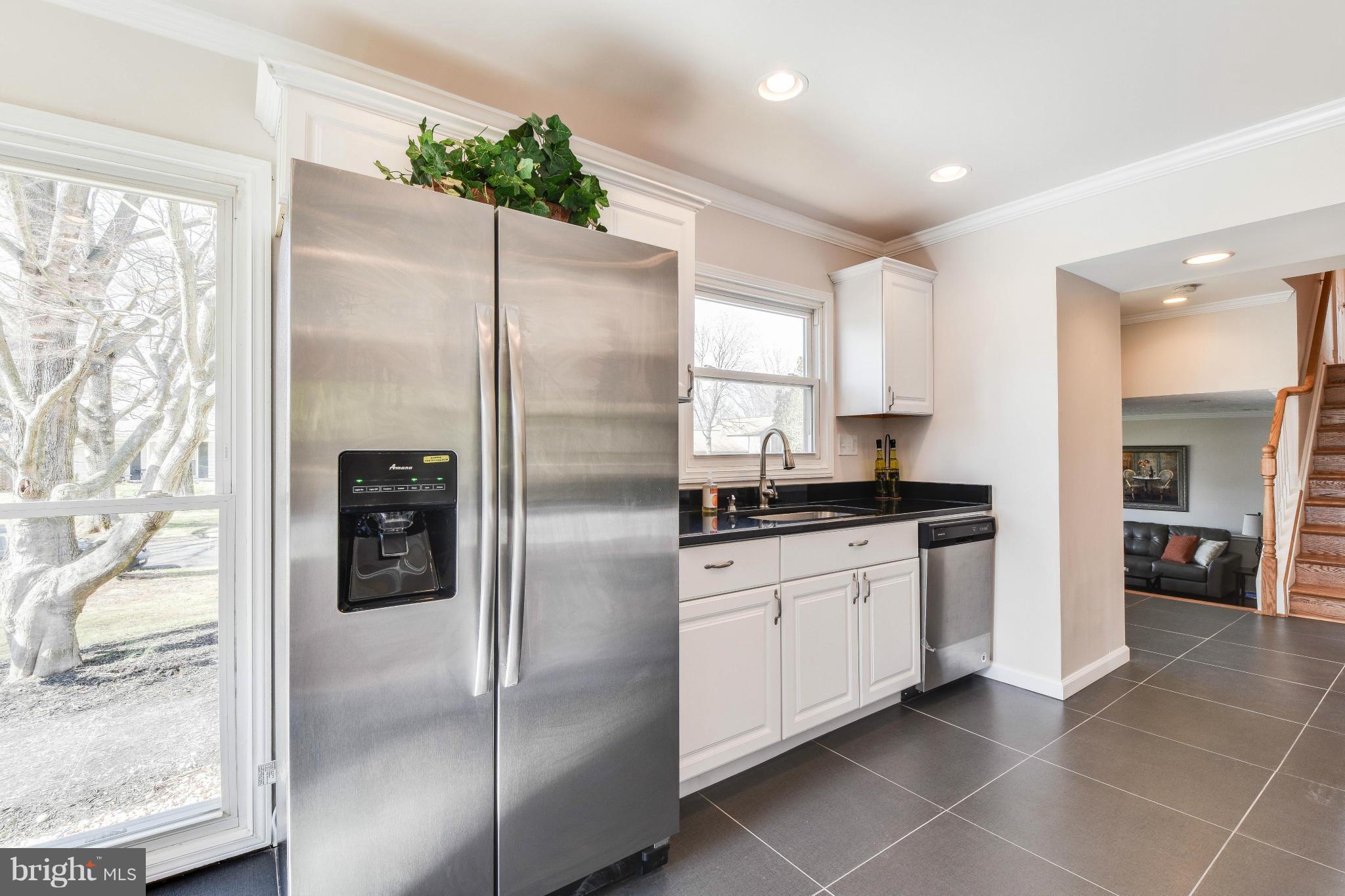 14001 Pond View Road Silver Spring, MD 20905 - Photo 7 of 30 a kitchen with stainless steel appliances granite countertop a refrigerator and a sink