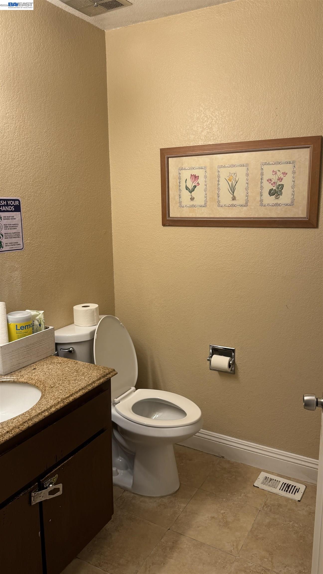 8206 Rhoda Avenue Dublin, CA 94568 - Photo 19 of 27 a bathroom with a granite countertop toilet and a sink