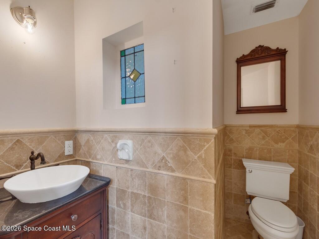167 Deer Run Road Palm Bay, FL 32909 - Photo 11 of 36 a bathroom with a toilet a sink and mirror