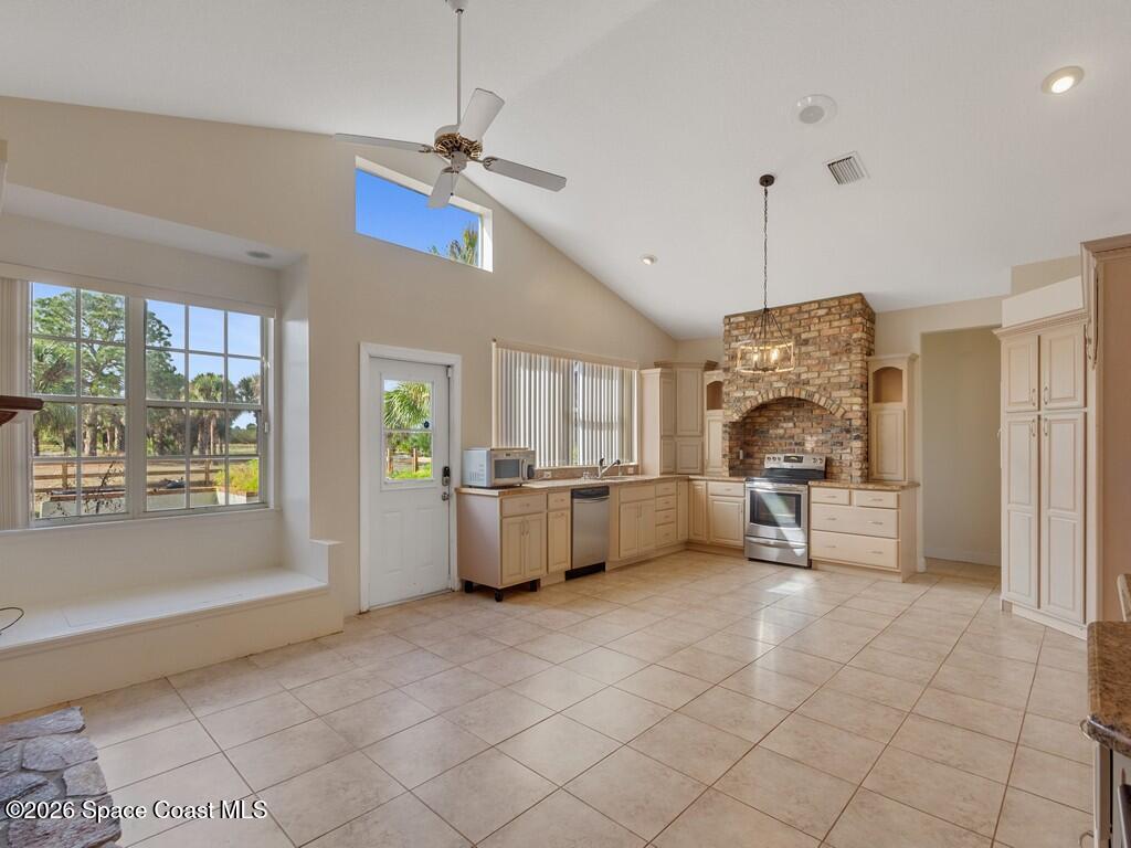 167 Deer Run Road Palm Bay, FL 32909 - Photo 12 of 36 a view of kitchen with windows and refrigerator