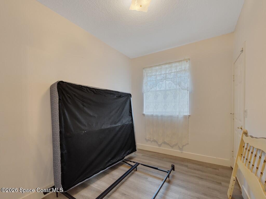 167 Deer Run Road Palm Bay, FL 32909 - Photo 17 of 36 a room with wooden floor and window