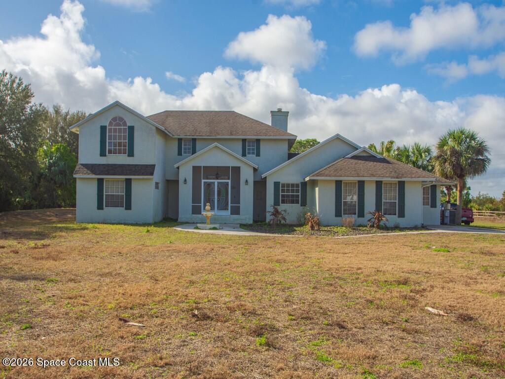 167 Deer Run Road Palm Bay, FL 32909 - Photo 2 of 36 a front view of a house with yard