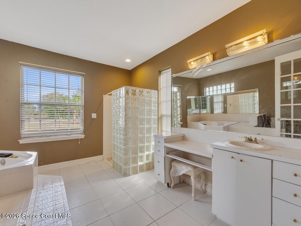 167 Deer Run Road Palm Bay, FL 32909 - Photo 22 of 36 a spacious bathroom with a granite countertop sink a toilet and a bathtub