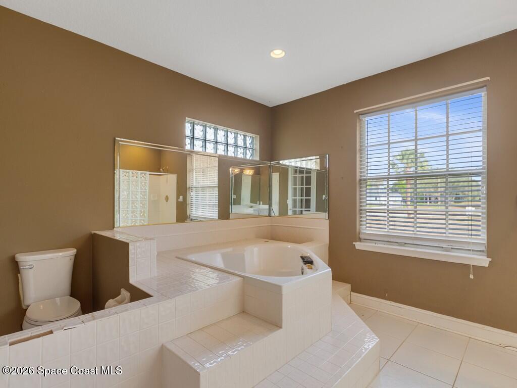 167 Deer Run Road Palm Bay, FL 32909 - Photo 23 of 36 a spacious bedroom with a large bed and a window