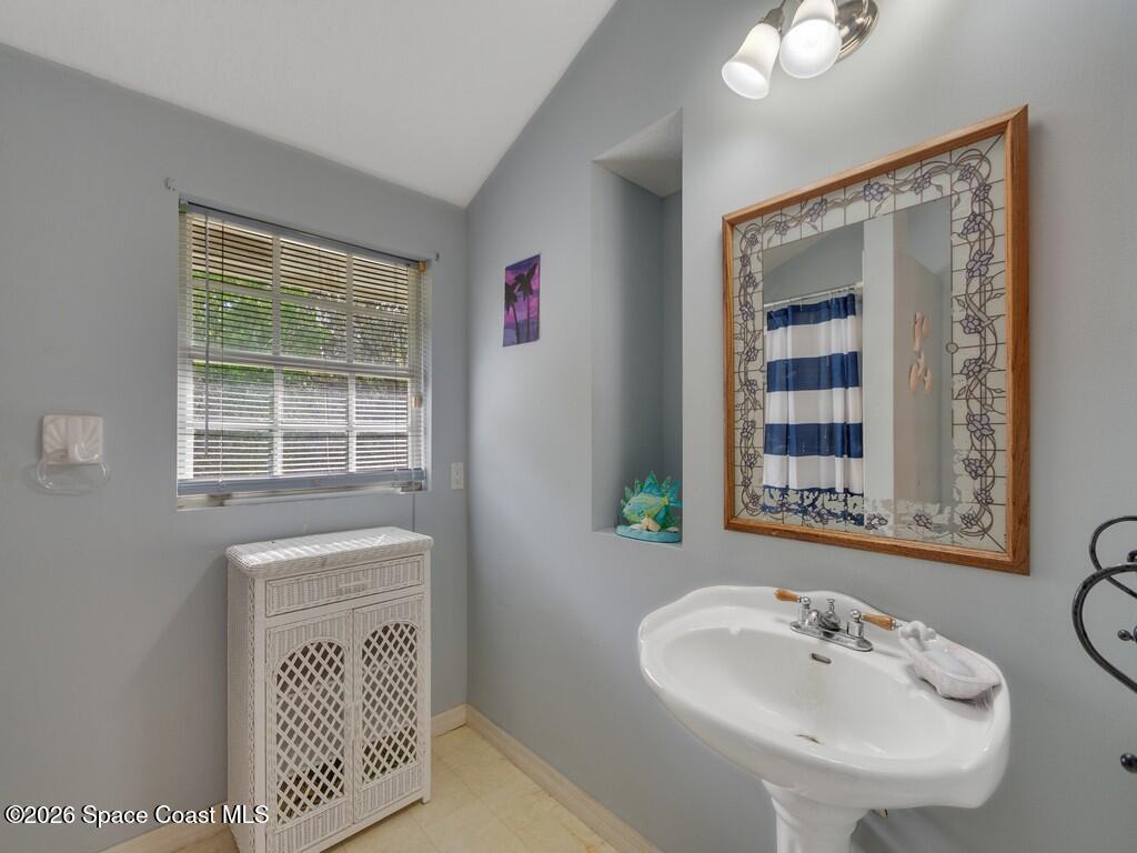 167 Deer Run Road Palm Bay, FL 32909 - Photo 28 of 36 a bathroom with a sink and a mirror