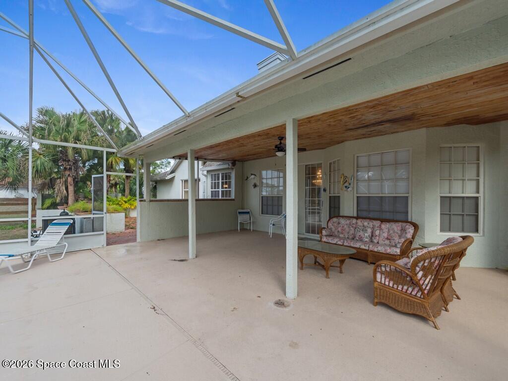 167 Deer Run Road Palm Bay, FL 32909 - Photo 30 of 36 a view of a patio with wooden table and chairs