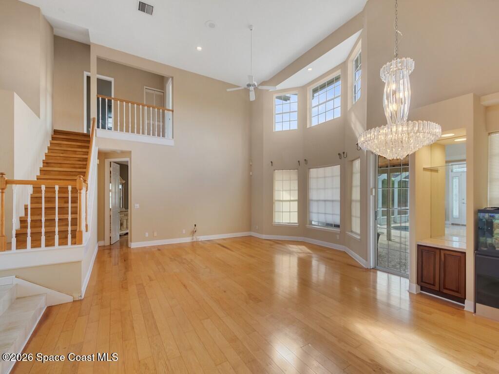 167 Deer Run Road Palm Bay, FL 32909 - Photo 9 of 36 a view of an empty room with wooden floor and a window