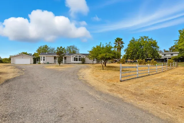a room with furniture a flat screen tv and a window