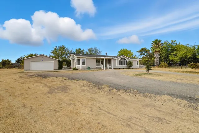 a spacious bedroom with a bed and a cabinets