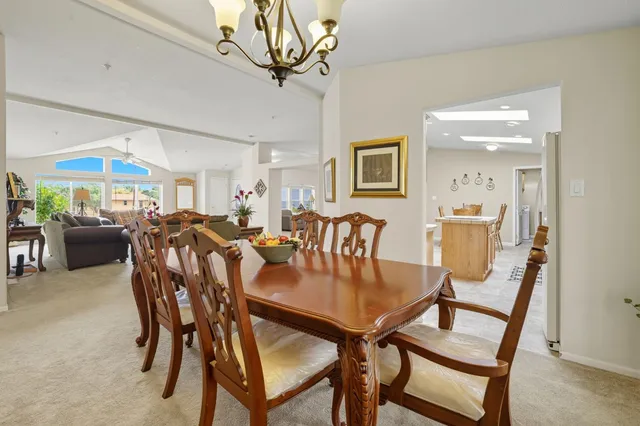 a spacious bathroom with a granite countertop sink a toilet and a mirror