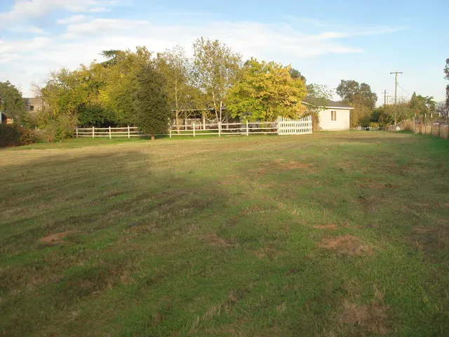 a view of a house with a yard and a garage