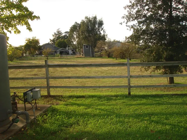 a bathroom with a sink vanity granite tub and a mirror