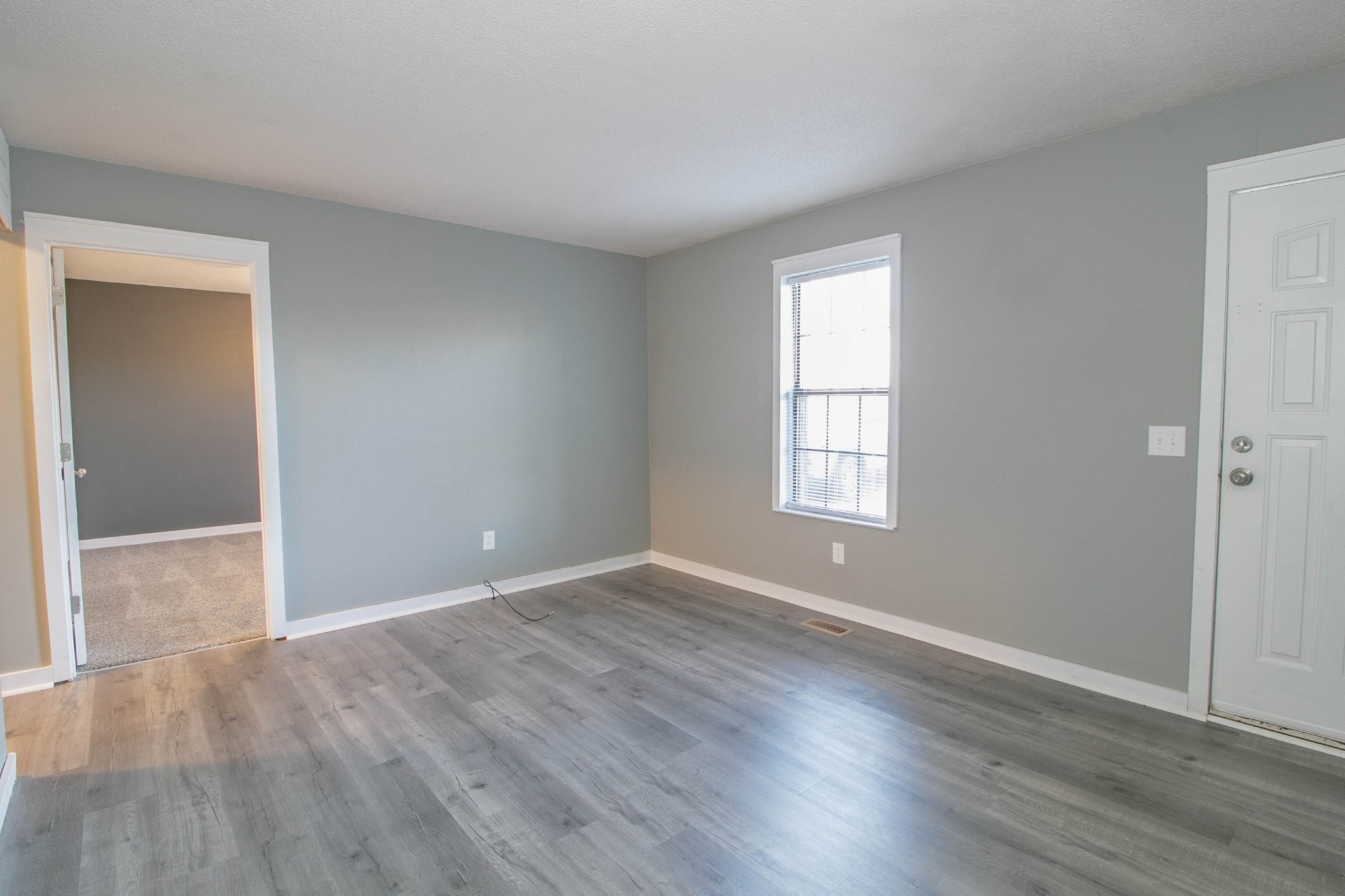 1088 Mcdaniel Road Clarksville, TN 37043 - Photo 41 of 71 a view of an empty room with wooden floor and a window