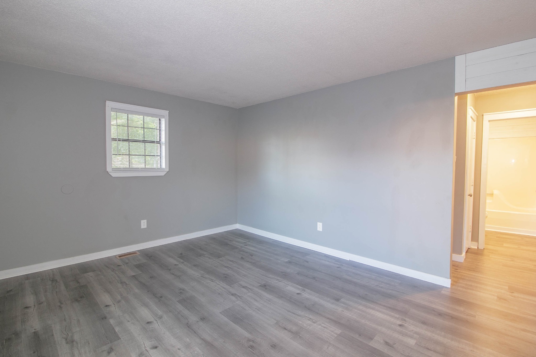1088 Mcdaniel Road Clarksville, TN 37043 - Photo 42 of 71 a view of an empty room with wooden floor and a window