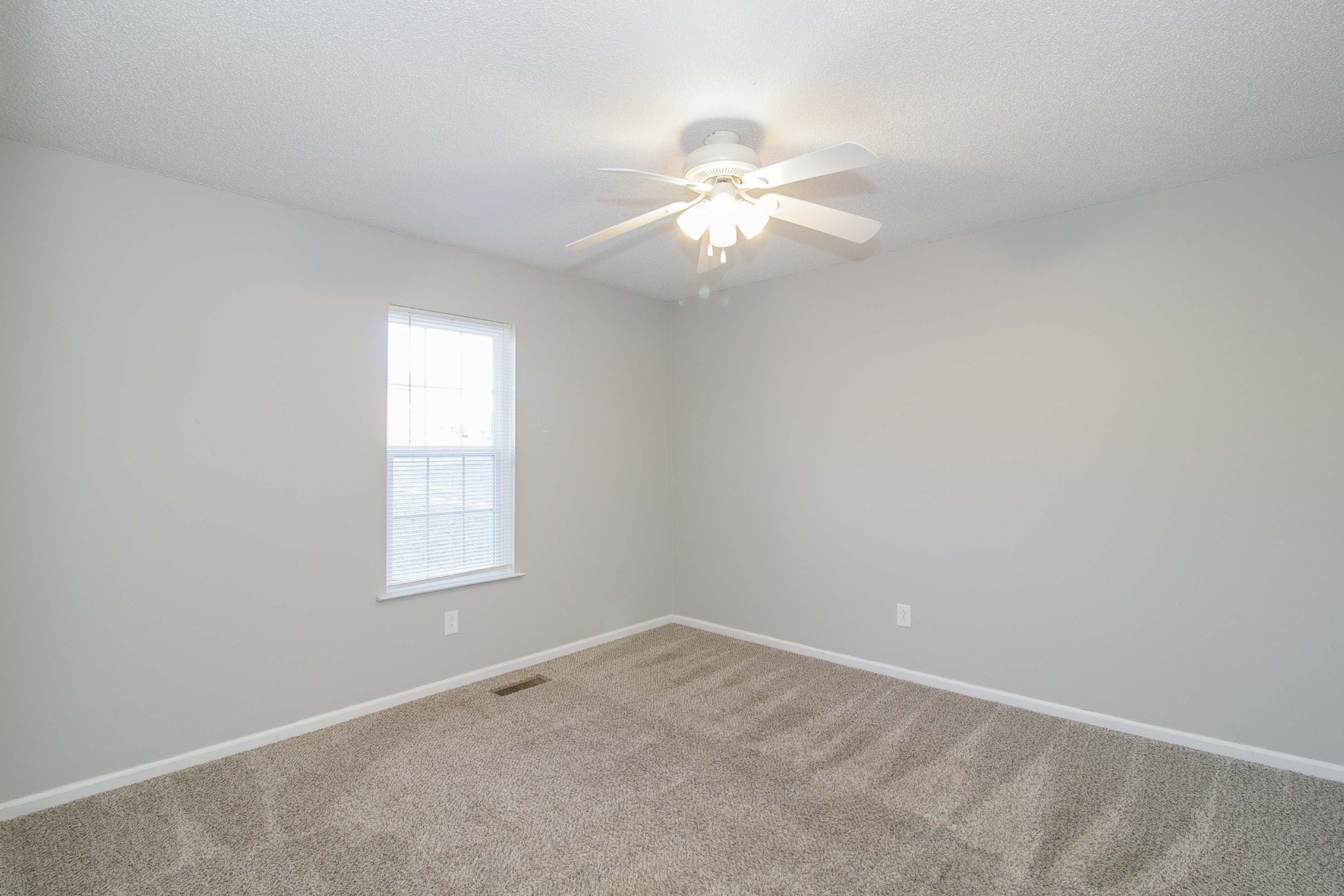 1088 Mcdaniel Road Clarksville, TN 37043 - Photo 58 of 71 an empty room with windows and chandelier fan