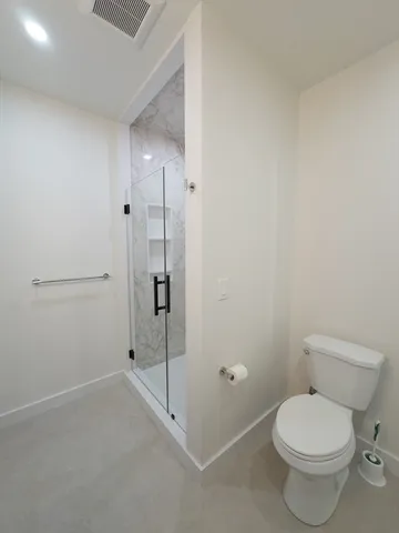 a bathroom with a shower and toilet