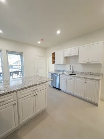 a kitchen with stainless steel appliances a refrigerator sink and cabinets