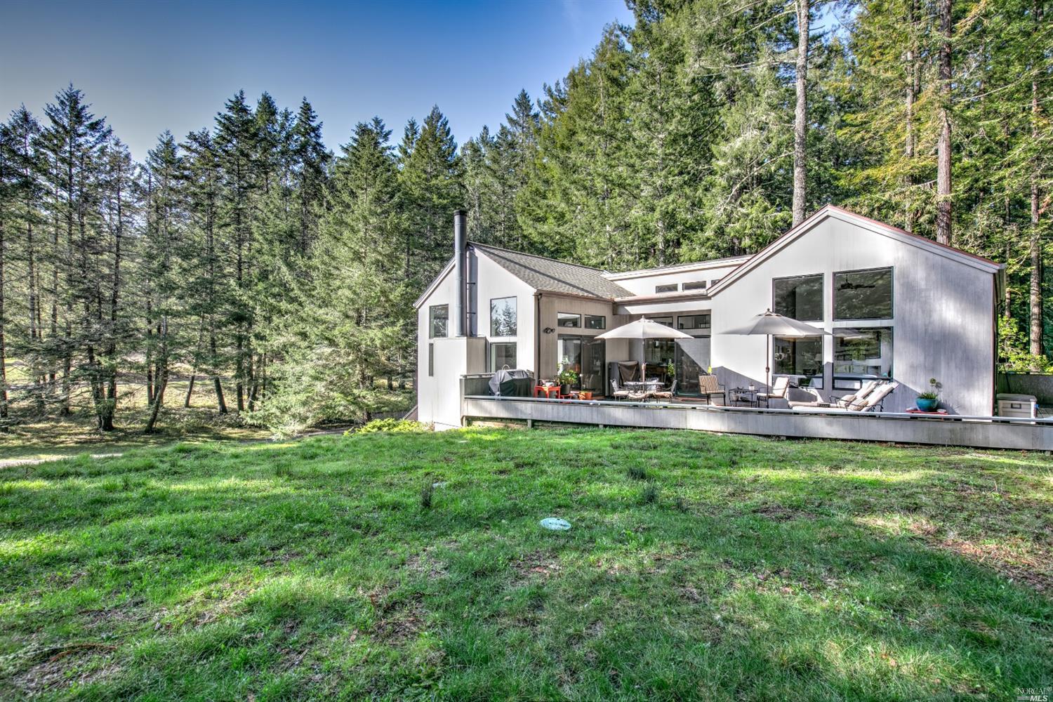 a front view of a house with yard patio and green space