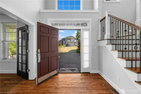 a view of a hallway view with wooden floor and staircase