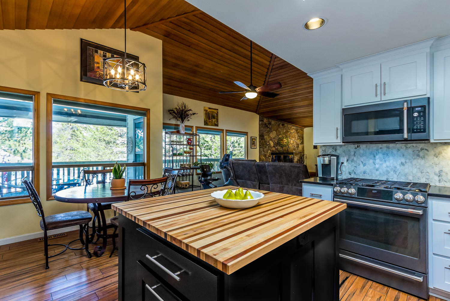 17704 Rogue Lane Sunriver, OR 97707 - Photo 14 of 26 a kitchen with a kitchen island wooden cabinets and stainless steel appliances