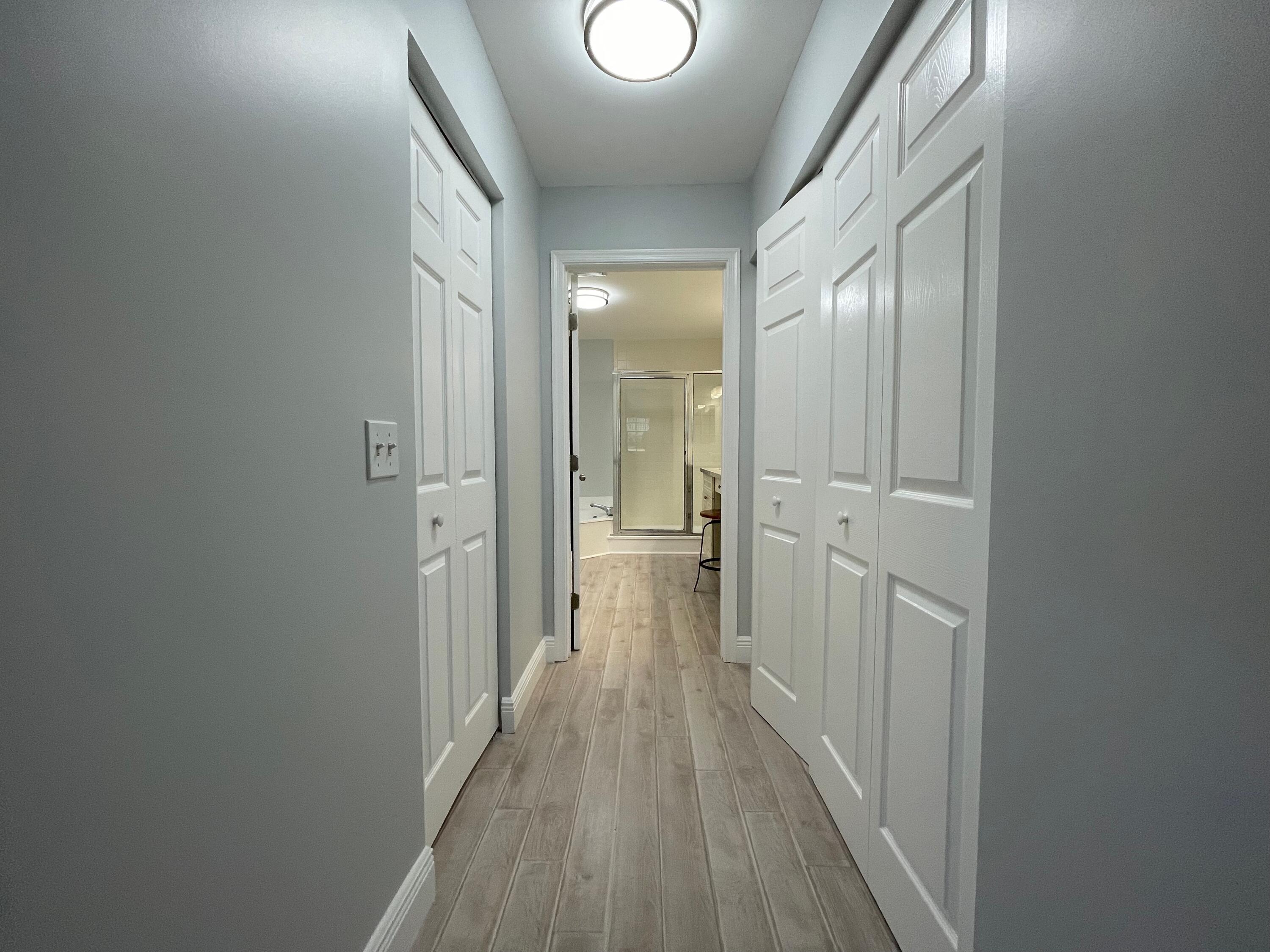 6691 Montego Bay Boulevard, Unit H Boca Raton, FL 33433 - Photo 13 of 22 a view of a hallway with wooden floor