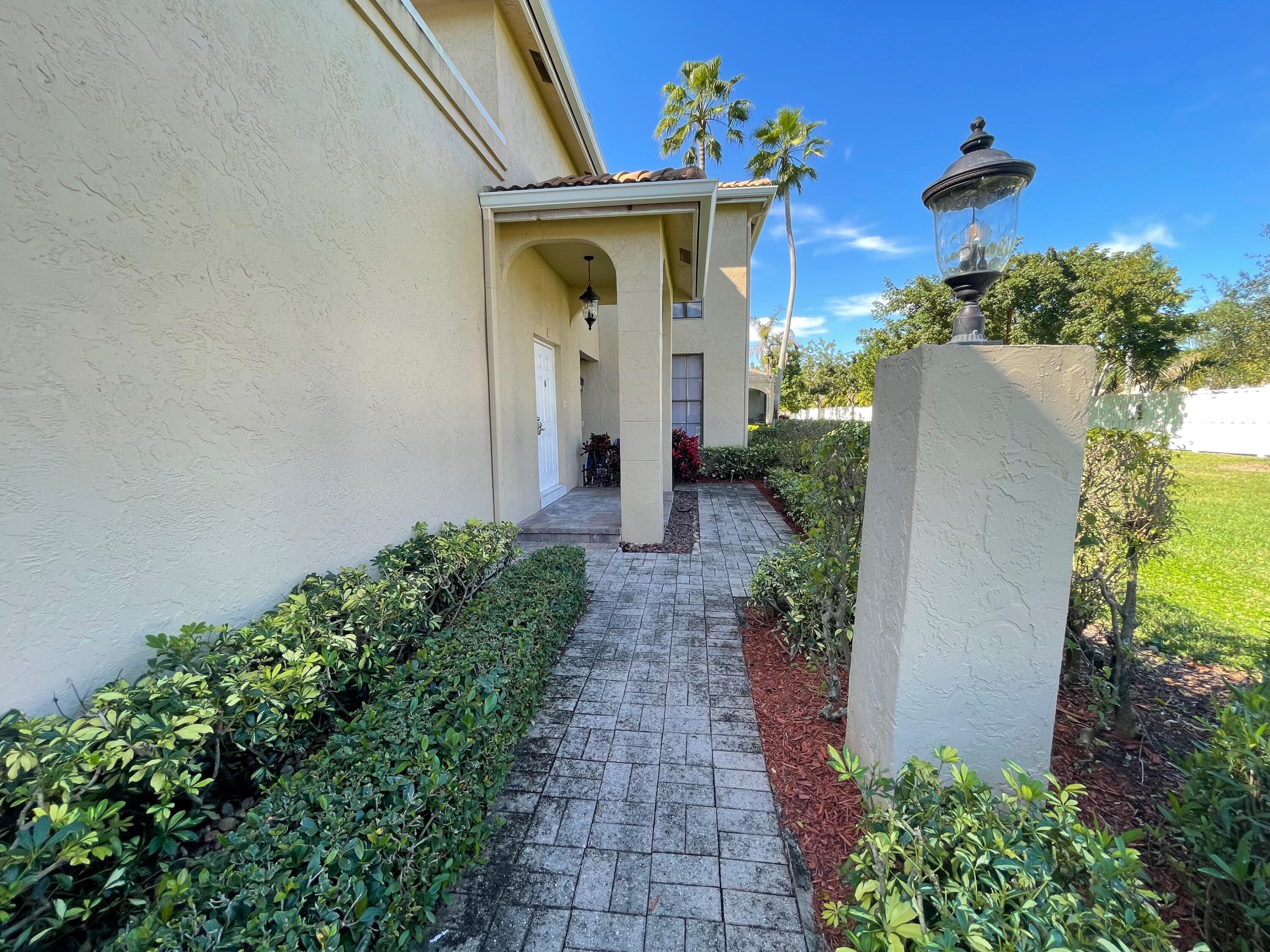6691 Montego Bay Boulevard, Unit H Boca Raton, FL 33433 - Photo 20 of 22 a front view of a house with garden