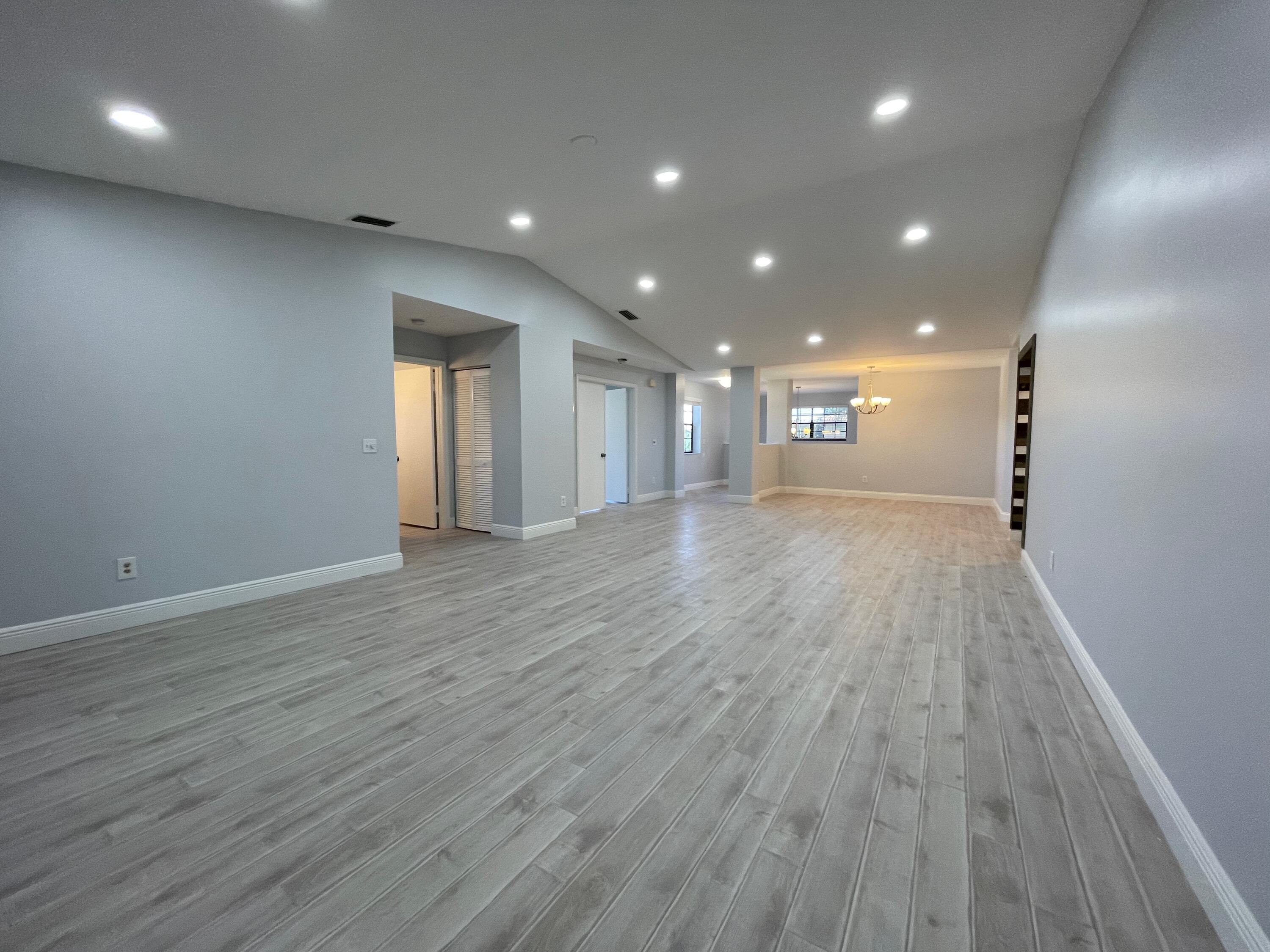 6691 Montego Bay Boulevard, Unit H Boca Raton, FL 33433 - Photo 3 of 22 a view of an empty room with wooden floor