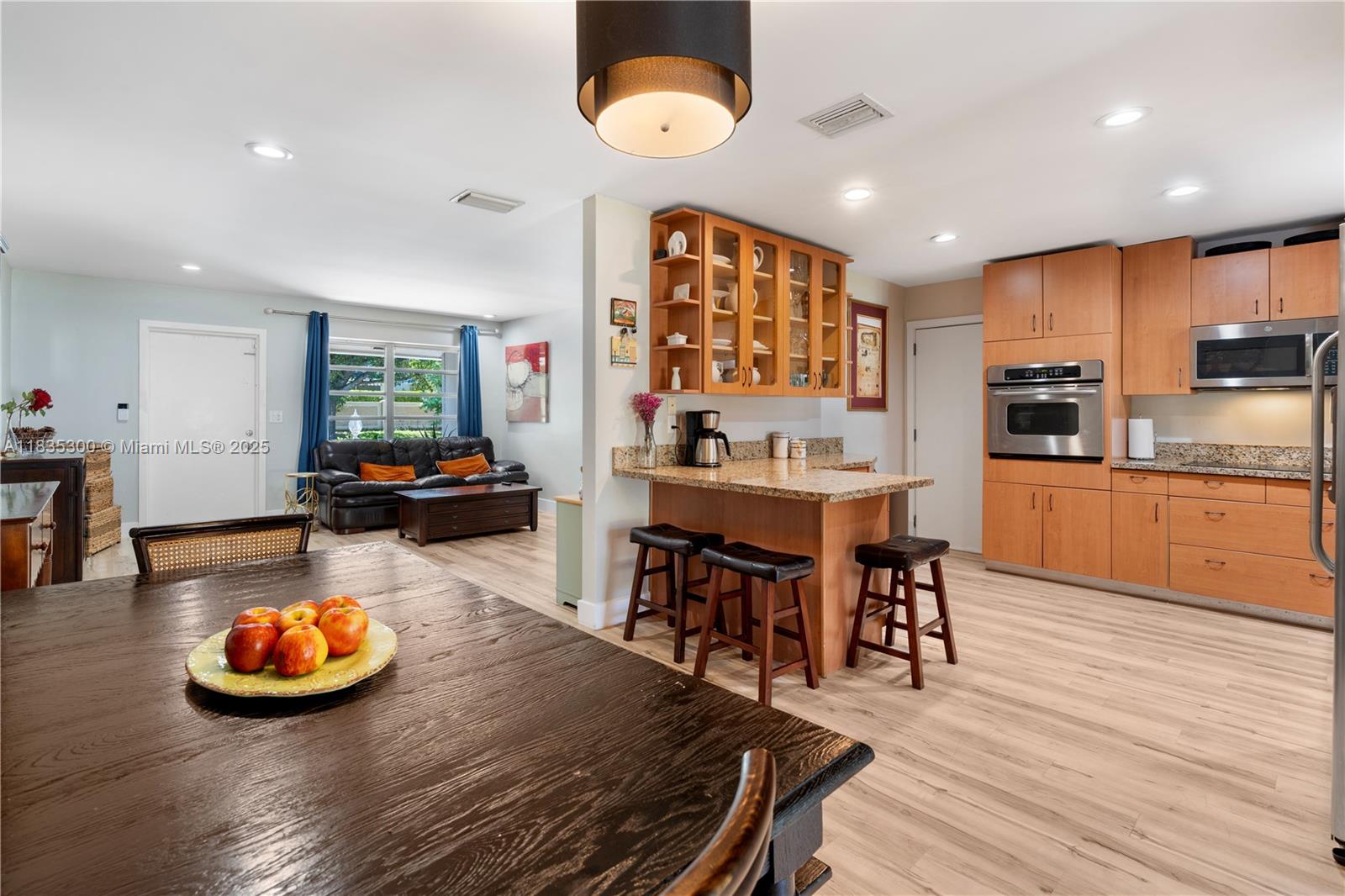 a view of a dining room with furniture kitchen and wooden floor