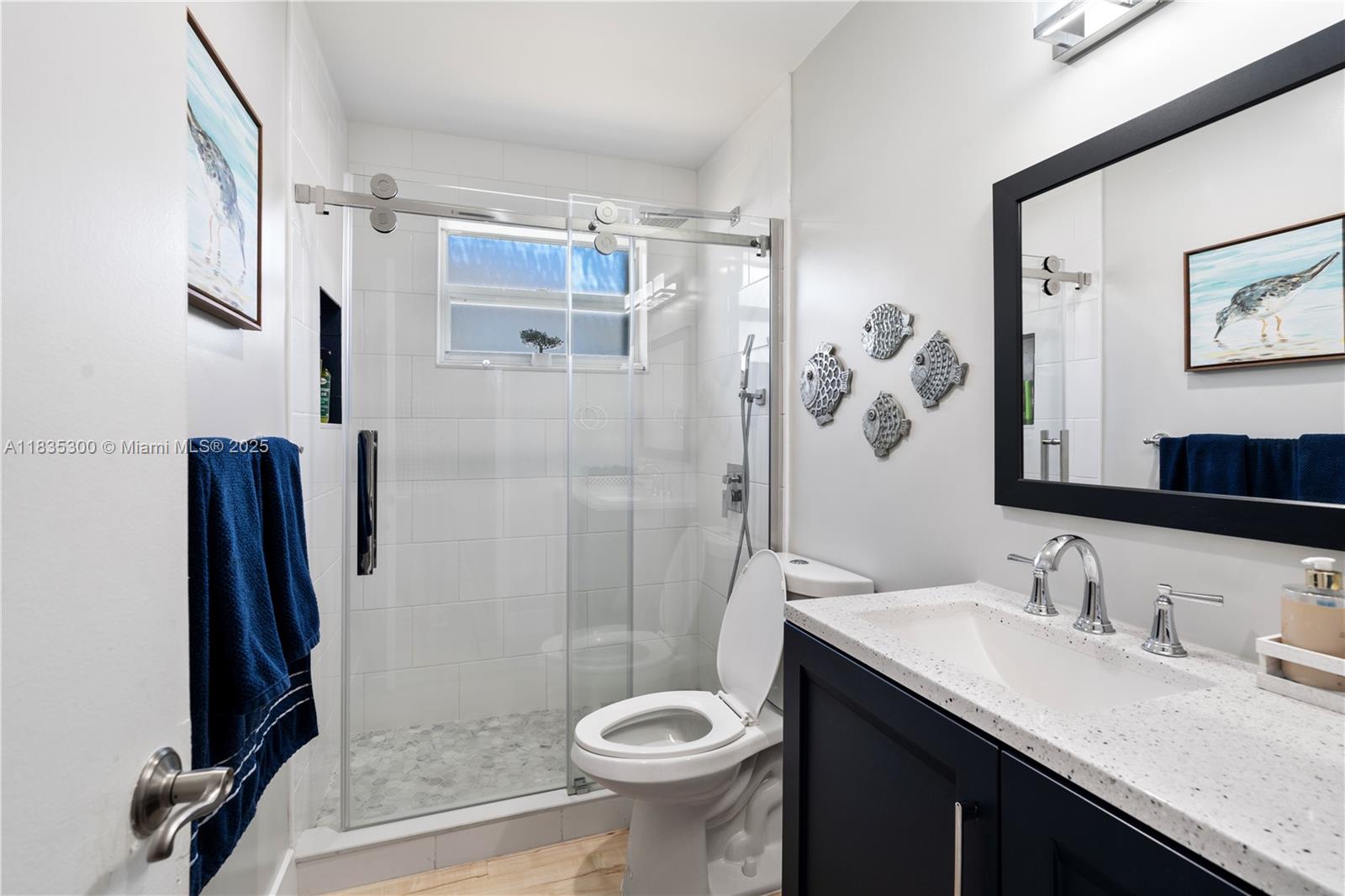 4025 Washington Street Hollywood, FL 33021 - Photo 12 of 24 a bathroom with a granite countertop sink toilet and shower