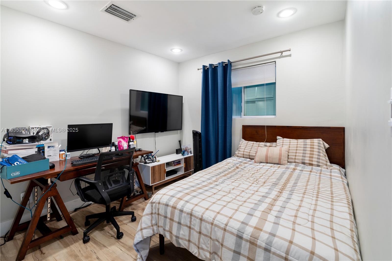 4025 Washington Street Hollywood, FL 33021 - Photo 13 of 24 a bedroom with a bed and a flat screen tv