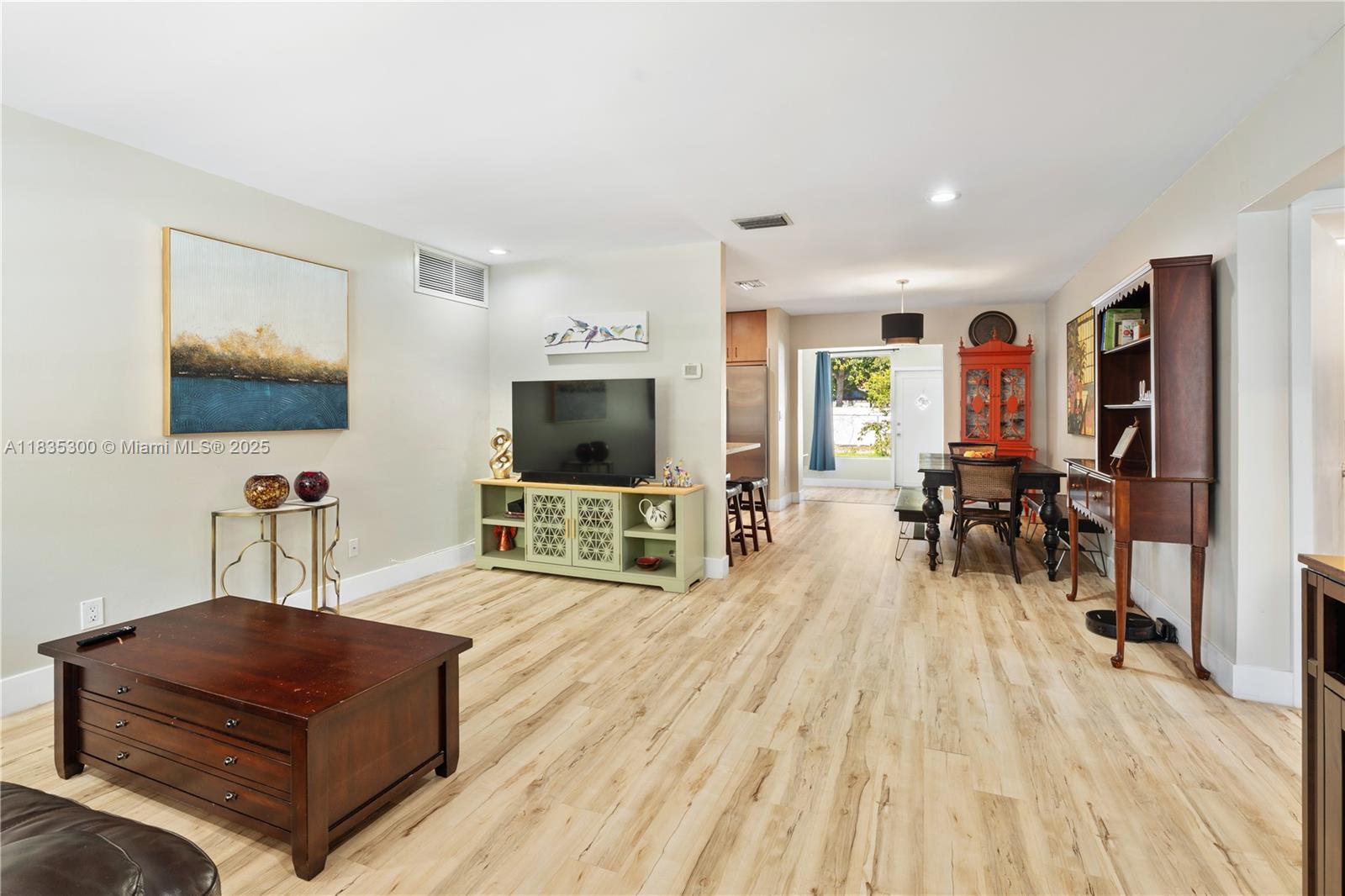 4025 Washington Street Hollywood, FL 33021 - Photo 2 of 24 a living room with furniture and a flat screen tv