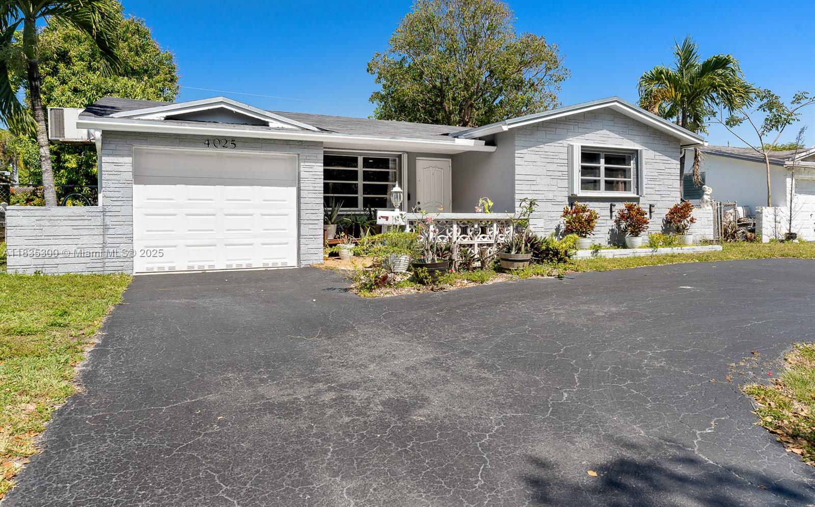 4025 Washington Street Hollywood, FL 33021 - Photo 21 of 24 a front view of a house with a yard and garage
