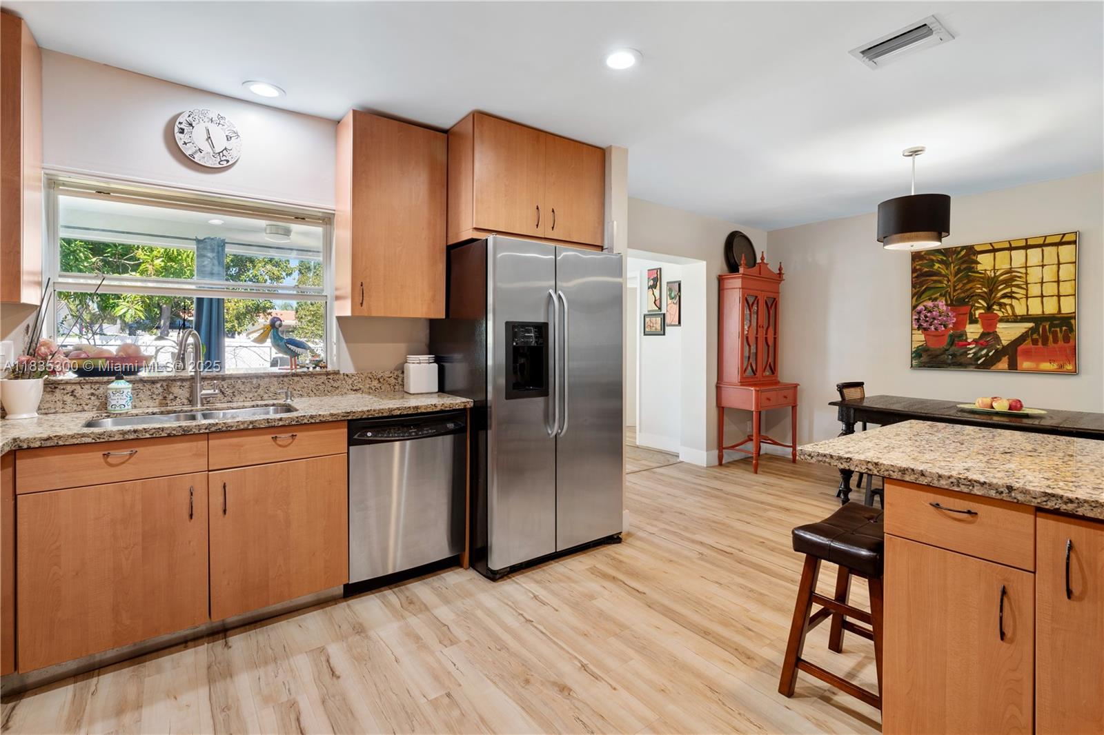 4025 Washington Street Hollywood, FL 33021 - Photo 5 of 24 a kitchen with stainless steel appliances granite countertop a refrigerator and a sink